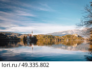 Lake Bled in the Alpine mountains in autumn under blue sky. Стоковое фото, агентство Ingram Publishing / Фотобанк Лори