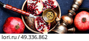 hookah with pomegranate. Exotic smoking shisha in east style with tobacco aroma of pomegranate.Fruit hookah. Стоковое фото, агентство Ingram Publishing / Фотобанк Лори