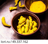 Roots and turmeric powder. Curcuma powder and root turmeric in a bowl. Стоковое фото, агентство Ingram Publishing / Фотобанк Лори