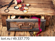 Thread spools and buttons. Wooden retro cupboard ,with thread spools and buttons. Sewing accessories. Стоковое фото, агентство Ingram Publishing / Фотобанк Лори