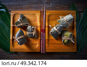 Zongzi Glutinous sticky Rice Dumplings recipe wrap with bamboo leaves asian food. Стоковое фото, агентство Ingram Publishing / Фотобанк Лори
