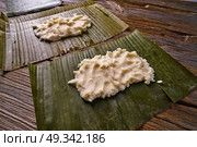 Tamale preparation Mexican recipe with banana leaves and cornmeal. Стоковое фото, агентство Ingram Publishing / Фотобанк Лори