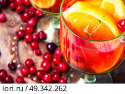 Refreshing Sangria drink. Sangria with orange and berries in a glass goblet. Стоковое фото, агентство Ingram Publishing / Фотобанк Лори