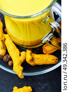 Healthy golden milk. Turmeric Golden milk in a glass cup. Стоковое фото, агентство Ingram Publishing / Фотобанк Лори