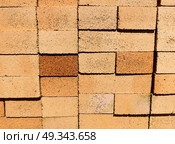 Stacked bricks in construction site showcasing earthy tones and textures during daylight. closeup. Стоковое фото, фотограф ЛУНИНА ВЕРОНИКА / Фотобанк Лори