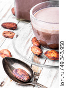 Cup of cappuccino coffee. Cup of cocoa drink and cocoa beans. Стоковое фото, агентство Ingram Publishing / Фотобанк Лори
