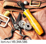 Tools of a tanner for working with leather. Working tools and cut out pieces of leather. Стоковое фото, агентство Ingram Publishing / Фотобанк Лори