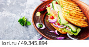 Sandwiches on plate. Sandwiches with beef bacon,cheese,lettuce and onions.Fast food. Стоковое фото, агентство Ingram Publishing / Фотобанк Лори
