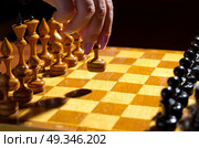 Chessboard with figures on dark background. Стоковое фото, агентство Ingram Publishing / Фотобанк Лори