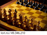 Chessboard with figures on dark background. Стоковое фото, агентство Ingram Publishing / Фотобанк Лори