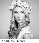 Portrait of a beautiful blonde woman with flowers in her hair. Portrait of a beautiful blonde woman with flowers in her hair. Fashion photo. Стоковое фото, агентство Ingram Publishing / Фотобанк Лори