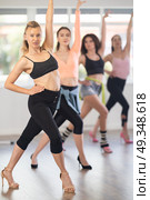 Female instructor performing graceful sass dance movements during group class. Стоковое фото, фотограф Яков Филимонов / Фотобанк Лори