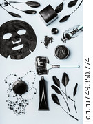 Beauty facial cosmetic products with Activated Charcoal: powder, Black head Mask, sheet mask and beauty tools accessories , top view, flat lay. Modern skin care concept. Стоковое фото, агентство Ingram Publishing / Фотобанк Лори
