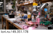 Robotic arm conducting precision tasks in a modern laboratory setting during day time. Стоковое AI-изображение, AI-художник Сергей Толмачёв / Фотобанк Лори
