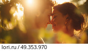 A couple is hugging in the sun, with the woman smiling. Стоковое AI-изображение, AI-художник Ярославский Максим / Фотобанк Лори