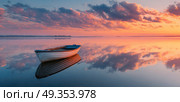 A small boat is floating on a calm lake at sunset. Стоковое AI-изображение, AI-художник Ярославский Максим / Фотобанк Лори
