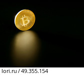 Bitcoin BTC coin reflection on the black soil. Bitcoin BTC coin reflection on the black soil background. Стоковое фото, агентство Ingram Publishing / Фотобанк Лори