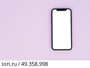 WARSAW, POLAND - DECEMBER 02, 2017: New Iphone X mobile phone on pink background with copy space. New Iphone X. New Iphone X. Редакционное фото, агентство Ingram Publishing / Фотобанк Лори