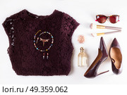 Fashion Christmas flat lay scene. Fashion flat lay scene. Hight heel leather shoes, lacy dress, dressing up for party fashion accessoires. Стоковое фото, агентство Ingram Publishing / Фотобанк Лори