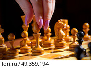 Chessboard with figures on dark background. Стоковое фото, агентство Ingram Publishing / Фотобанк Лори