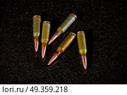 Ammunition cartridges on black background. Ammunition cartridges. Стоковое фото, агентство Ingram Publishing / Фотобанк Лори