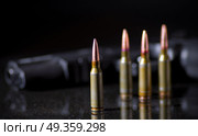 Ammunition cartridges on black background. Ammunition cartridges. Стоковое фото, агентство Ingram Publishing / Фотобанк Лори