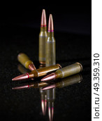 Ammunition cartridges on black background. Ammunition cartridges. Стоковое фото, агентство Ingram Publishing / Фотобанк Лори