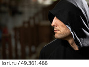 Profile of the man in a hood on a black background      . Strong man. Стоковое фото, агентство Ingram Publishing / Фотобанк Лори