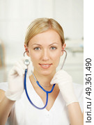 The doctor with a statoscope in a medical suit. The doctor with a statoscope. Стоковое фото, агентство Ingram Publishing / Фотобанк Лори