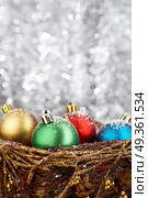 Multi-coloured balls on a silvery flickering background. Christmas balls. Стоковое фото, агентство Ingram Publishing / Фотобанк Лори