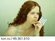 The thoughtful girl holds in a hand of a tablet and reflects on the developed situation. Condition of a hopelessness. Стоковое фото, агентство Ingram Publishing / Фотобанк Лори