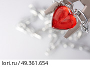 Heart clamped by pliers wound by a chain. Love in bondage. Стоковое фото, агентство Ingram Publishing / Фотобанк Лори