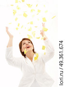 The beautiful woman throws above a head yellow scraps of a paper on a white background. Good-bye paper work! Стоковое фото, агентство Ingram Publishing / Фотобанк Лори