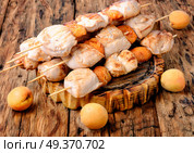 Turkey meat on barbecue grill,cooked on skewers with apricot .BBQ. Baked turkey meat. Стоковое фото, агентство Ingram Publishing / Фотобанк Лори