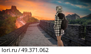 a woman with a backpack travels along the Great Wall of China. Стоковое фото, агентство Ingram Publishing / Фотобанк Лори