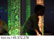 Young kid exploring snoezelen space. Young kid exploring a multi sensory space - snoezelen concept. Стоковое фото, агентство Ingram Publishing / Фотобанк Лори