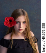 Blond kid girl portrait with hibiscus red flower on hair. Стоковое фото, агентство Ingram Publishing / Фотобанк Лори