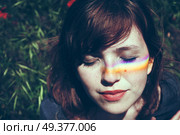 Young woman with a rainbow in her face. Стоковое фото, агентство Ingram Publishing / Фотобанк Лори