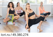 Female instructor performing graceful sass dance movements during group class. Стоковое фото, фотограф Яков Филимонов / Фотобанк Лори