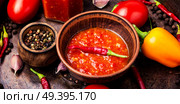 Homemade sauce adjika with pepper, garlic and tomatoes.Barbeque sauce. Spicy seasoning, adjika sauce. Стоковое фото, агентство Ingram Publishing / Фотобанк Лори