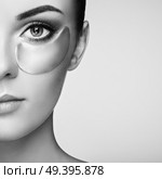Portrait of Beauty Woman with Eye Patches. Woman Beauty Face with Mask under Eyes. Beautiful Female with natural Makeup and Cosmetics Collagen Patches on Fresh Facial Skin. Стоковое фото, агентство Ingram Publishing / Фотобанк Лори