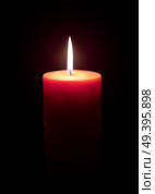 Burning candle isolated on black. Стоковое фото, агентство Ingram Publishing / Фотобанк Лори