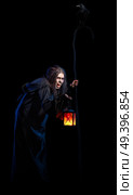Scary witch isolated on black with raven version. Стоковое фото, агентство Ingram Publishing / Фотобанк Лори