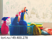 Spring cleaning - container with sprays, gloves and rubbers on windowsill, retro toned. Spring cleaning concept. Стоковое фото, агентство Ingram Publishing / Фотобанк Лори