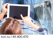 someone taping on modern laptop keyboard, double exposure with modern cityscape. hands on laptop keyboard. Стоковое фото, агентство Ingram Publishing / Фотобанк Лори