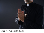 Praying hands priest portrait of male pastor. Стоковое фото, агентство Ingram Publishing / Фотобанк Лори