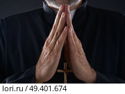 Praying hands priest portrait of male pastor. Стоковое фото, агентство Ingram Publishing / Фотобанк Лори