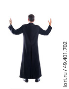 Full length priest blessing arm rear view of back soutane. Стоковое фото, агентство Ingram Publishing / Фотобанк Лори