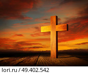 Christian wood cross on sunset sky wooden made. Стоковое фото, агентство Ingram Publishing / Фотобанк Лори