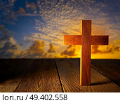 Christian wood cross on sunset sky wooden made. Стоковое фото, агентство Ingram Publishing / Фотобанк Лори
